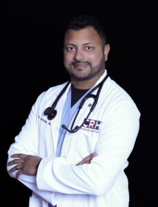 Image of Dr. Ian Furtado smiling with arms crossed